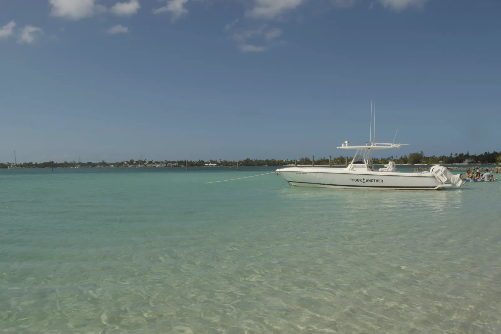 A motor yacht at anchor in clear water, the Bahamas