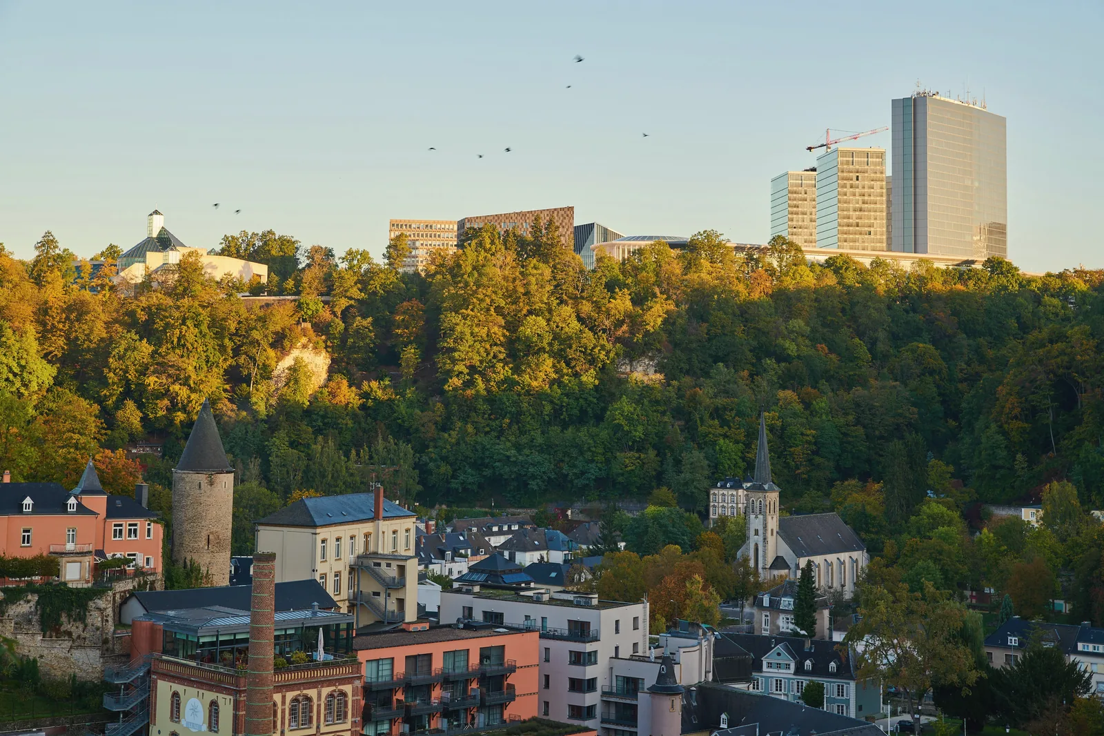 Kirchberg towers above the old town of Luxembourg City at sunrise
