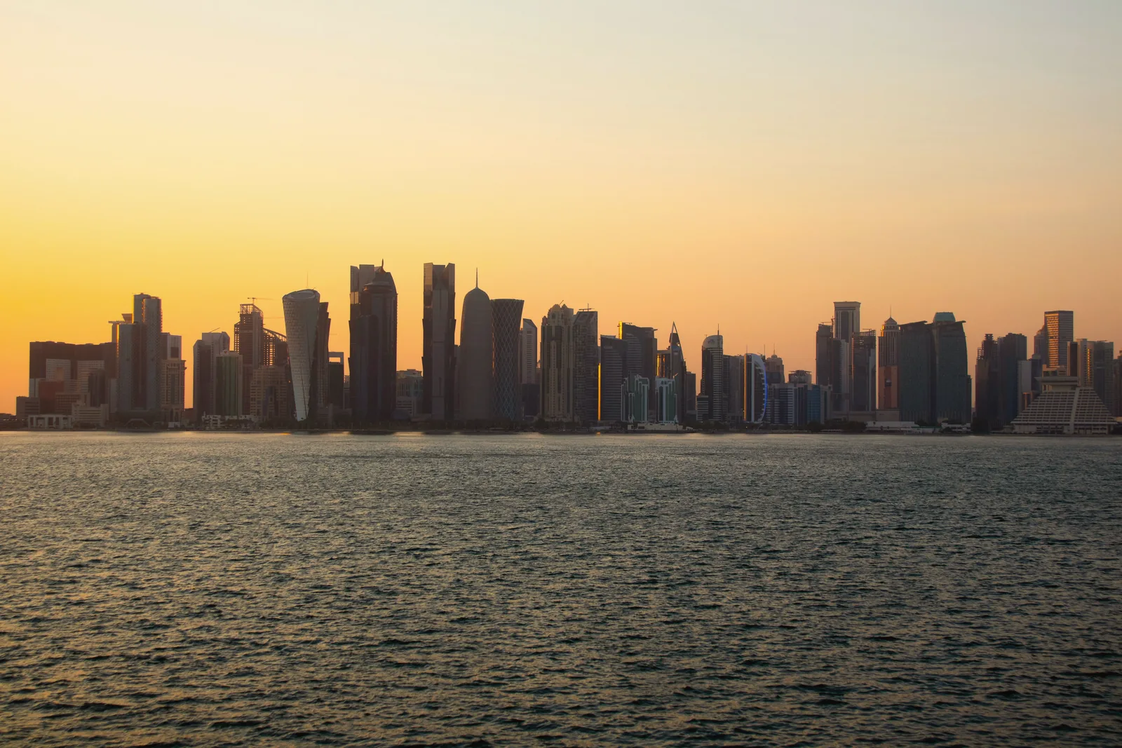 The Doha skyline seen from the water at sunset
